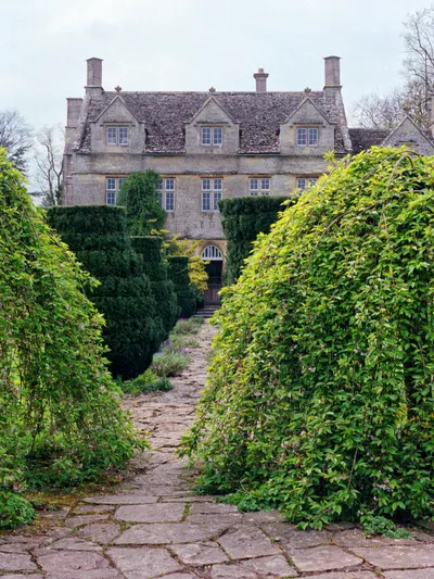 1992 Spring photograph along a path from the gardens at the east towards Barnsley House, at the time Rosemary Verey was in residence and directly caring for the garden.Processing: SLR camera Kodak Gold ASA 200-2 film negative scanned with an Epson Perfection V800 using SilverFast 8 scan program, and optimized, cropped and spun with DxO OpticsPro 10 Elite and Adobe Photoshop CS2.