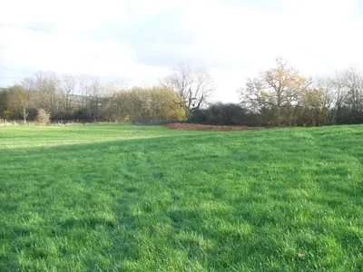 Across the field The footpath from Clapton-on-the-Hill crosses the field to the minor road.