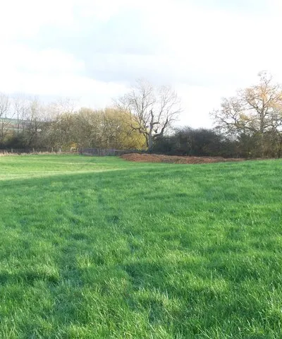 Across the field The footpath from Clapton-on-the-Hill crosses the field to the minor road.