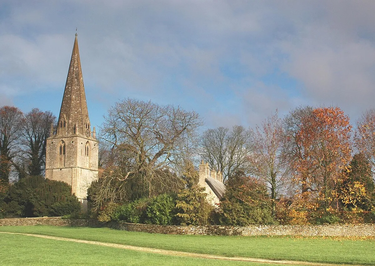 Broadwell, Oxfordshire: view loking northeast at steeple of St Peter's parish church &amp; thatched roof of cottages.