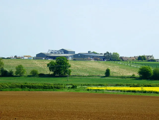 Airstrip at Manor Farm, Wadswick The airstrip is at the top of the field in front of the farm buildings. There are two aircraft to the left of the large tree and an airsock to the right.