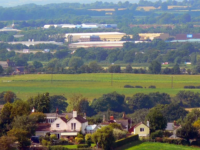 A view towards west Swindon This image was obtained from the high ground south of Wroughton with the Marlborough Downs behind the viewpoint and is facing north-west. In the foreground are residential properties in Church Hill, Wroughton at map reference SU140803. The nearest commercial building above the trees in the centre is Batleys Cash and Carry in Frankland Road, Blagrove at SU115828 with, just behind it the yellowish Anchor Butter factory. Even further away is the Windmill Business Park at SU106834. The windmill that gives its name to the Park is visible near the top left corner of the image. The distance between the windmill and the viewpoint is 5.45 kilometres.