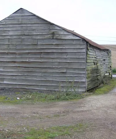 Barn at Winterbourne Farm This timber-clad barn is probably ready for some TLC.  Typical arable fields behind.