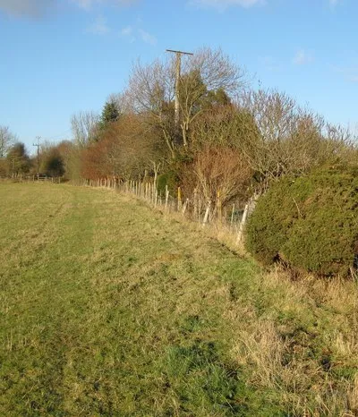 Boxford: Former Lambourn Valley Railway The old railway line from Newbury to Lambourn ran on just the other side of the field boundary fence here. The line opened in 1898 and closed to regular passenger and freight traffic on 4 January 1960, fifty years previously bar a day from the date that the photograph was taken. Occasional military freight trains for RAF Welford used the line until 1973 and the track was lifted around 1976. The site of the former railway station at Boxford is over the fence at the corner of the field in the distance.