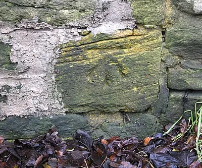 Benchmark on wall of North Street