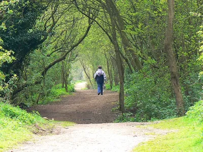 Footpath on the eastern bank, Keynes country park The park is a leisure destination based around a lake formed from old mineral workings. There are several walks available. The facility is popular with dog walkers. This view is across the western gridline of this square.