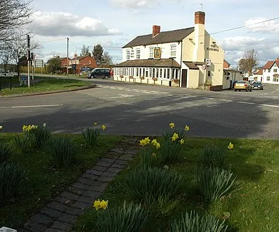 Daffodils and the Blue Bell. The Blue Bell Inn on the A38 at Ryall, the white house in the background to the right was another pub called the Horse and Groom until it closed about three years ago. After a long cold winter the daffodils are much later this year, compare this with a similar view from 2008 715283