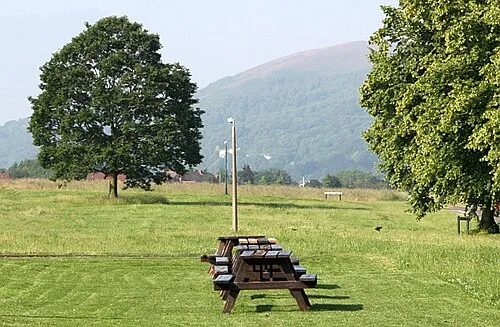 Alignment of pub benches on Poolbrook Common Outside the Three Horse Shoes.
Pinnacle hill in the distance.