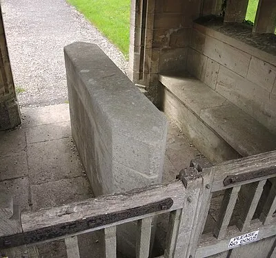 A lych gate with a stone