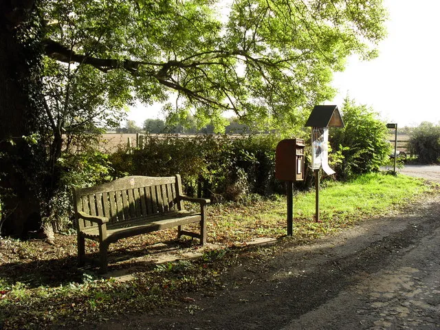 Wooden bench, post box and notice board in Grafton, Oxfordshire. The bench is the village's commemoration of the Golden Jubilee of Elizabeth II.