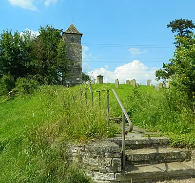 Gravestones and the tower of St Oswald's Church, Lassington