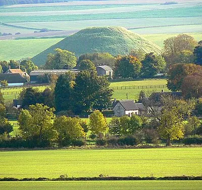 Avebury Trusloe, Avebury Avebury Trusloe is a small settlement west of its more famous neighbour. The conical hill in the background is Silbury Hill, said by some to be the remains of a load of old shoes dumped there by an itinerant cobbler on his way to (or perhaps from, I can't remember) Marlborough. This explanation is as likely as any other I've heard for the hill's existence.