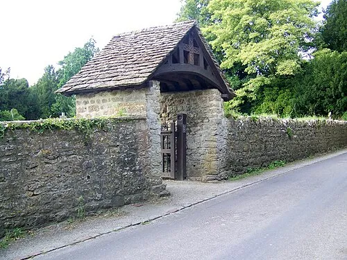 Lych gate, St Mary's Church, Purton, near to Purton, Wiltshire, Great Britain.
Many churches have a lych gate built over the main entrance to the enclosed area round the church. The name, also spelt lich or lytch, is from the Anglo Saxon 'lich' meaning corpse. The gate marks the division between consecrated and unconsecrated ground, where the bearers sheltered with the coffin, waiting for the clergyman to lead the procession before the burial. The original lych gates had seats, a lych cross and a lych stone - a slab on which the coffin rested.