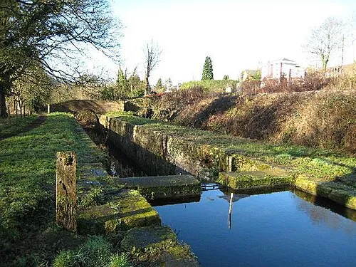 Beale's Lock, Brimscombe Tidied up and with the masonry in a reasonable condition but with the top gates currently replaced by a dam.  The GWR Gloucester - Swindon line is on the bank to the right and the site of Brimscombe Station as just beyond the red barrier.
