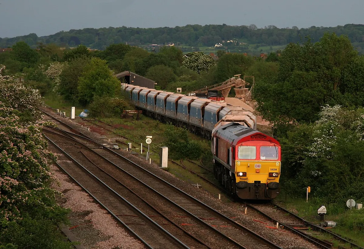 7C66 TX-Q 19:41 Wootton Bassett-Merehead MendipRail 59 empty bogie hoppers prepares to leave Wooton Bassett with 59 204 in charge.