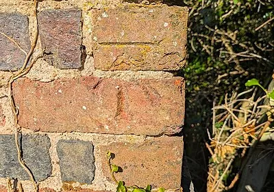 Benchmark on SE end of railway bridge parapet on NE side of Station Road
