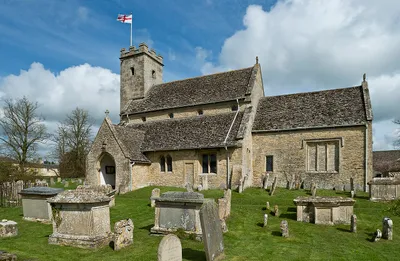 A 12th century church with later enlargements. The tower was added in 1822. Swinbrook is famous for the Fettiplace monuments in the chancel, the Mitford family graves in the churchyard and the restored medieval glass fragments in one window.