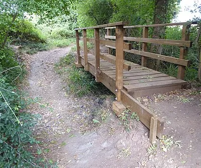 A footbridge and dried up stream