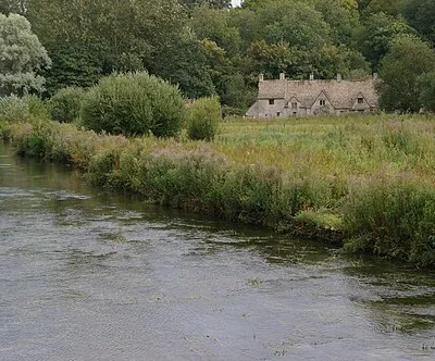 Bibury: cottages on Arlington Row, seen across the meadows on Rack Isle