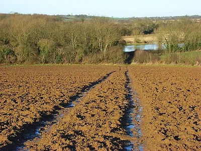 Bridleway at Prescote, Oxfordshire. A waterlogged bridleway descending to the road near Broadmoor Bridge. Below are the floodwaters of Highfurlong Brook.