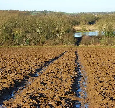 Bridleway at Prescote, Oxfordshire. A waterlogged bridleway descending to the road near Broadmoor Bridge. Below are the floodwaters of Highfurlong Brook.