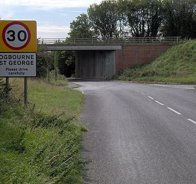 Bypass bridge, Ogbourne St George. The A346 now avoids the centre of Ogbourne St George via a  bypass. Originally the main road would have run closer to the camera, and turned to run under where the bridge now is. The bridge also marks where the railway line from Marlborough to Swindon formerly ran.