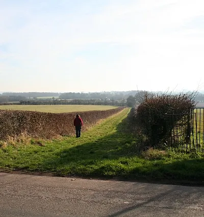 Bridleway and Footpath from the Hook A most curious arrangement (there must be a good story behind this), on one side of the hedge is a broad trackway which is a public bridleway whilst on the other side is a public footpath entered by a sheep proof kissing gate. the two combine at the bottom of the hill and the route continues up to Lower Hook.
