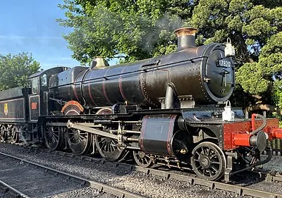 7820 Dinmore Manor gleaming in the evening sun with a Goods Train at Toddington station during the 2024 Cotswolds Festival of Steam Gala on the Gloucestershire Warwickshire Railway.
