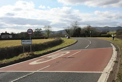Entrance to Welland On the bend of the A4104 road from Upton just before the Anchor pub.
The sign is in the parish of Upton.
The Welland parish boundary is at the next road junction.