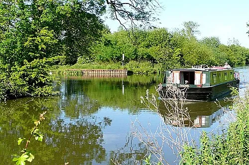 Canal west of Newbury The Kennet and Avon Canal approaches Newbury on the last rural section before the town. The approaching boat, Rachel, is operated by The Bruce Trust, providing canal holidays for disabled and handicapped people. Their four wide boats all have wheelchair access.