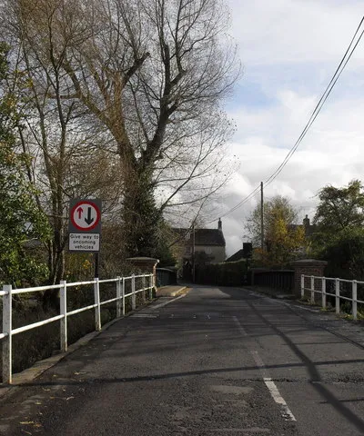 Bridge over the Thames in Castle Eaton The yellow sign to the left advertises the Red Lion, the "first pub on the Thames"