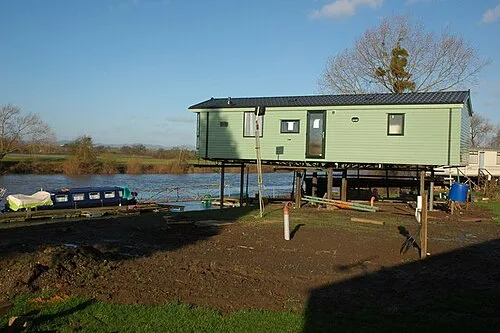 Caravan by the Coalhouse Inn, Apperley This caravan on the banks of the River Severn next to the Coalhouse Inn is one of many on stilts to raise them above flood waters.