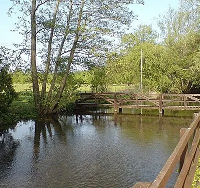 Ampney Brook The footbridge crosses from the Cross of Crucis hotel to the cricket ground