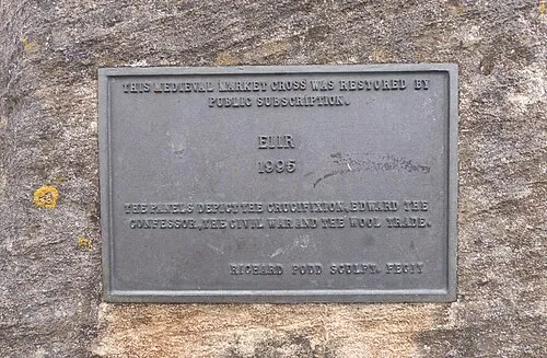 A plaque from the 1990s on the market cross in Stow-on-the-Wold, reflecting its renovation.