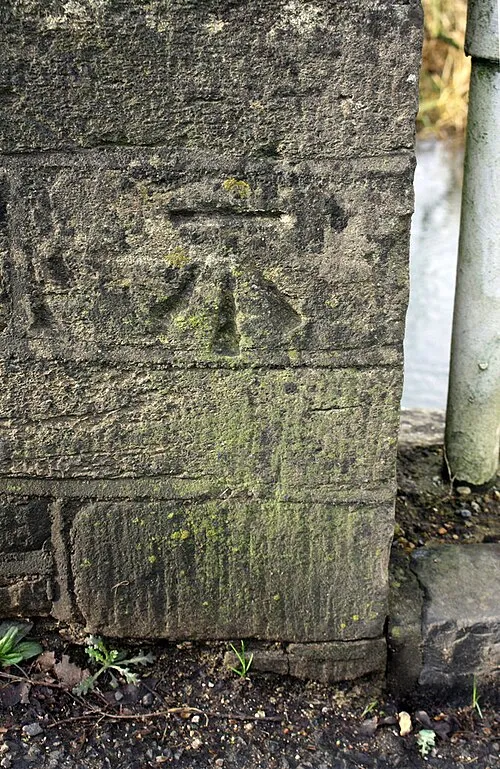 Benchmark on parapet of bridge over River Windrush