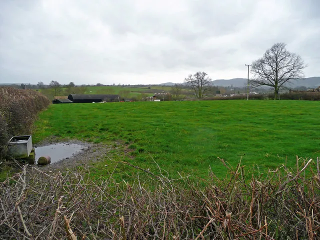 Across pastures to Woodside Farm The southern end of the Malvern Hills chain can be seen in the distance.