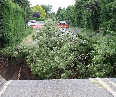 July 2007 Floods - Disintegrated B4084, Cropthorne A look down the hole created when flash flood water from Bredon Hill washed away the Pershore to Evesham road.