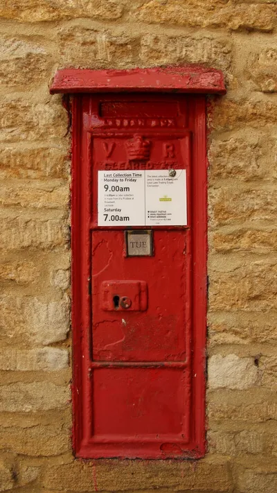 VR postbox mounted in the wall of Dossett's Old School, Kencot, Oxfordshire