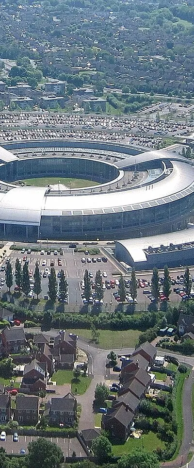 Government Communications Headquarters, Cheltenham, Gloucestershire, England. Built 2002.
Quote from the GCHQ website: “Employing over 6,000 people from a range of diverse backgrounds, we strive to keep Britain safe and secure by working with our partners in the Secret Intelligence Service (MI6) and MI5. Our headquarters is based in Cheltenham, with regional hubs in Scarborough, Bude, Harrogate and Manchester”. 

Looking south-east from a Piper Cherokee Warrior (reg G-BBXW) during a pleasure flight from Gloucestershire Airport.