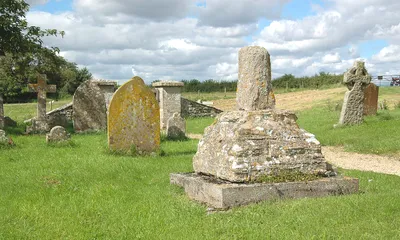 Base and broken shaft of 15th-century stone cross in the chapel yard of St Mary, Shifford, Oxfordshire