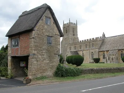 Church and lych gate, Long Compton. The lych gate at Long Compton is unusual in that it is a small cottage with a room on the first floor above the entrance.