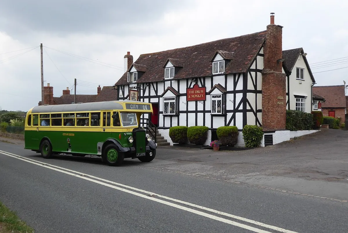 A vintage bus arriving at the Drum and Monkey