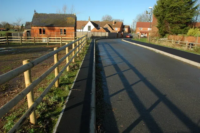 Access road to new housing in Stoke Orchard New road giving access to modern recently built houses in Stoke Orchard, the former chapel is on the left.