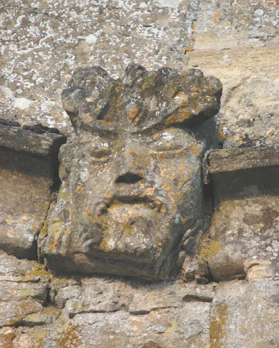 Church of England parish church of St Kenelm, Enstone, Oxfordshire: grotesque on the outside of the church.