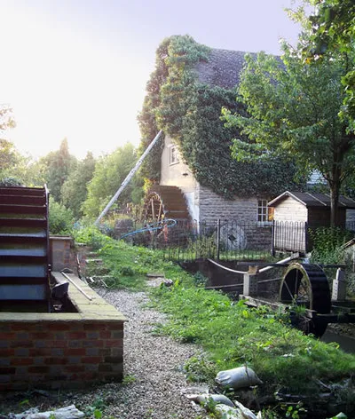 Little Clanfield Mill, Little Clanfield, Oxfordshire. The old mill has been turned into a house but there is still a mill in use using the water wheel in the left foreground.