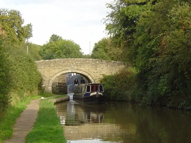 Narrowboat passing under Bridge 213 at Pigeon Lock on the Oxford Canal at Kirtlington, Oxfordshire: view from the south