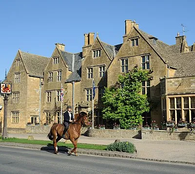 A rider passes in front of the Lygon Arms hotel in Broadway, a Cotswolds village. The first recorded date in the history of The Lygon Arms (then the White Hart Inn) is in 1532, when the Broadway Parish Register noted its owner as Mr Thomas White, a local wool merchant.
Oliver Cromwell, who became Lord Protector of England in 1653, stayed at The Inn on 2nd September 1651, the night before the Battle of Worcester, the final and decisive battle of the great Civil War, fought between King Charles I and his "Cavaliers" and Parliament's "Roundheads".