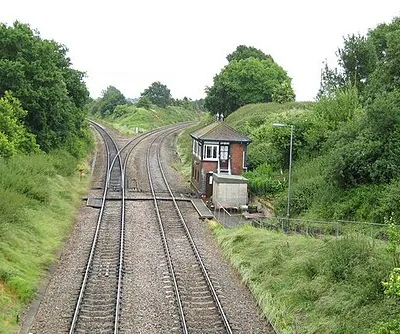 Norton Junction The single track railway leading off to the left is the line to Oxford from Worcester via Pershore, Evesham, etc.. It was built as the Great Western Railway's Oxford Worcester and Wolverhampton branch line and was originally double-tracked, losing that status in the 1970s. Off to the right the double tracked railway is the line to Cheltenham Spa from Worcester which joins up with the Birmingham to Cheltenham Spa line about a kilometre around the corner at Abbots Wood Junction. The signal box has a couple of typical GWR finials on its roof.