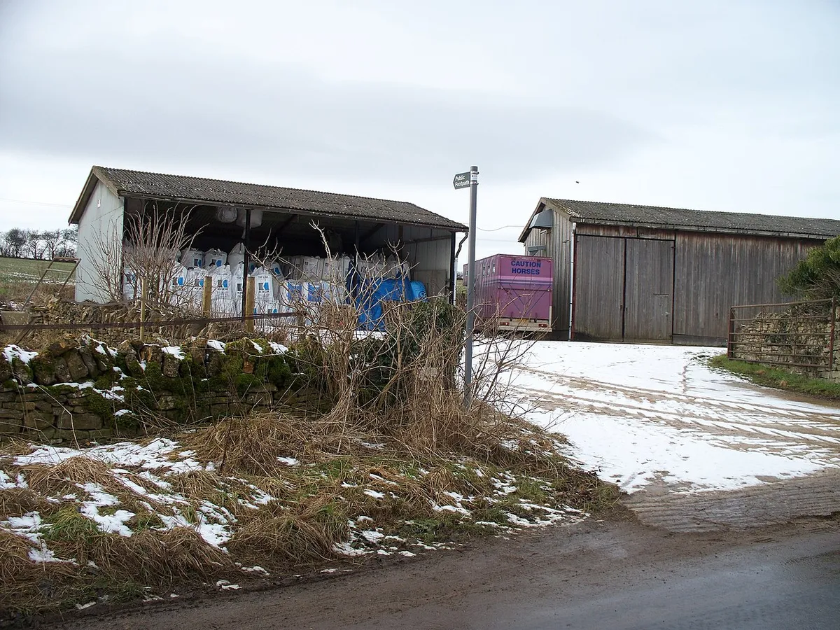 Barns at the start of the footpath The footpath leaves the minor road through Kineton and heads towards Castlett Farm.  The barns are part of Home Farm.