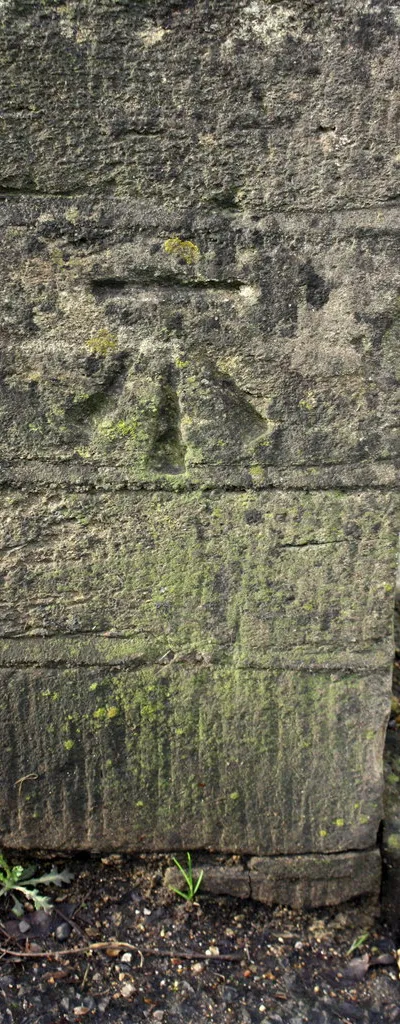 Benchmark on parapet of bridge over River Windrush